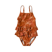 Brown ruffled swimsuit with palm tree pattern on a white background