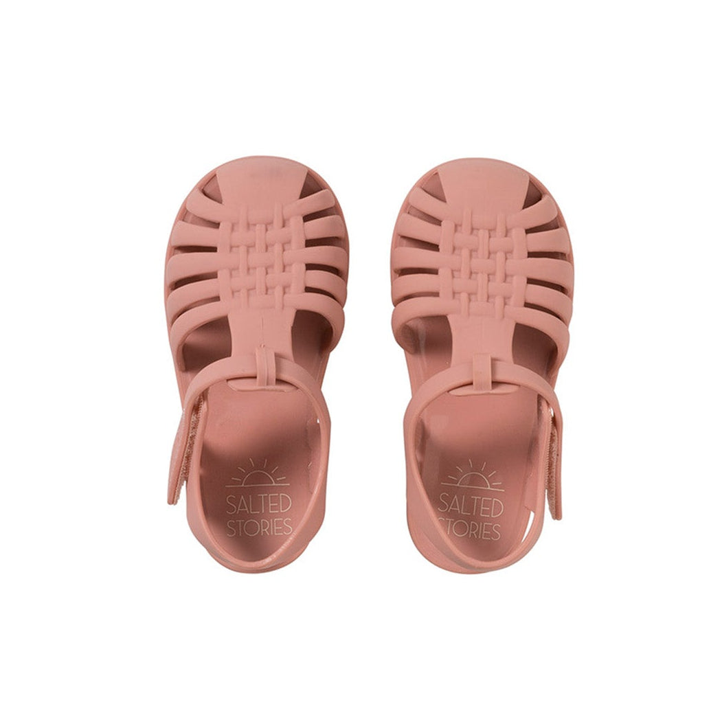 Pair of pink sandals on a white background