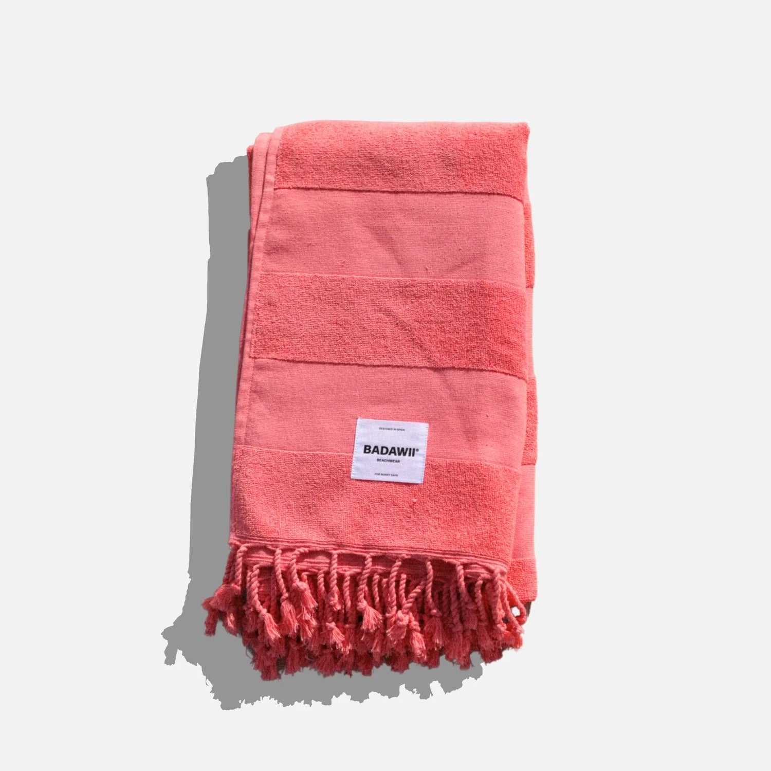 Red towel with a brand label on a white background