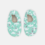 Pair of green baby shoes with animal pattern on a white background