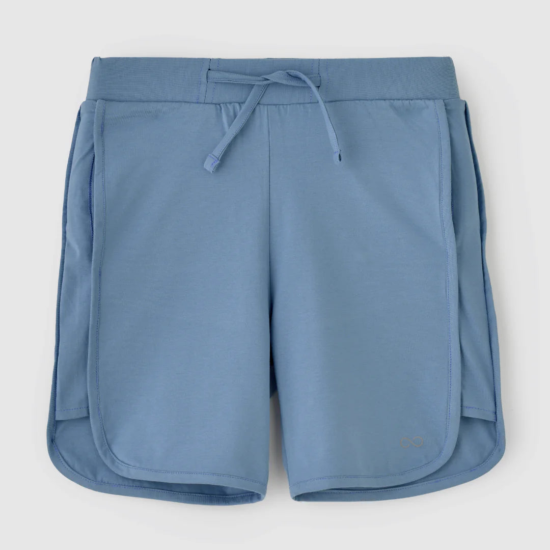 A pair of misty blue shorts with a drawstring waist and a small logo on the left leg.